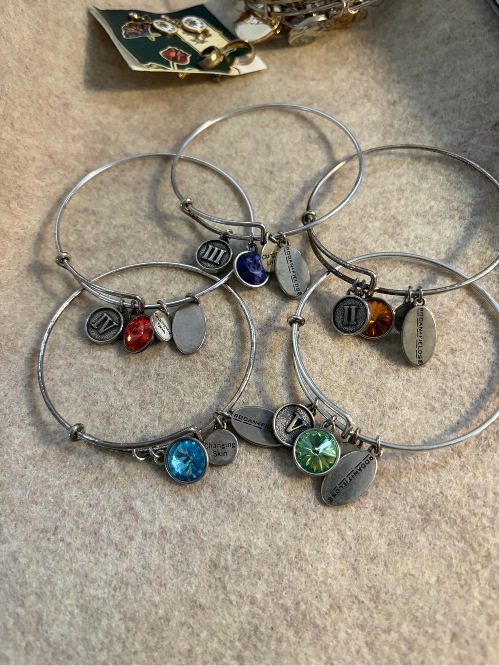 Rodan + Fields Silver Charm Bangle Set with Blue, Green, Orange and Red Crystals